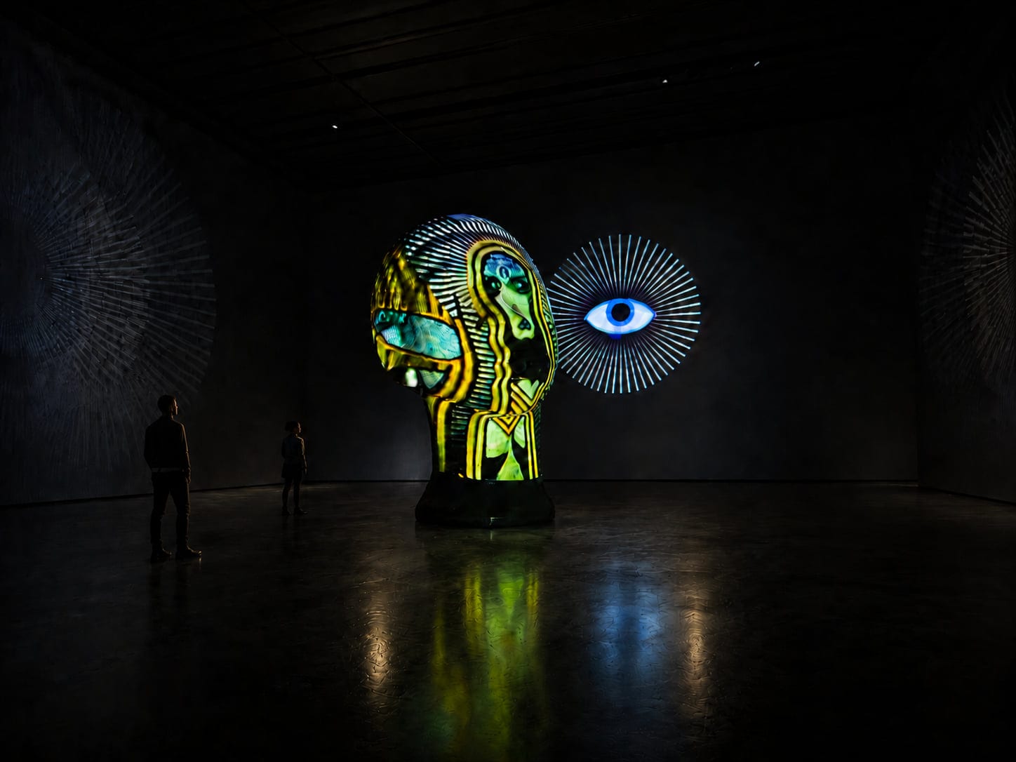 Projection-mapped sculpture glowing in a darkened gallery — CMD immersive systems and projection environments