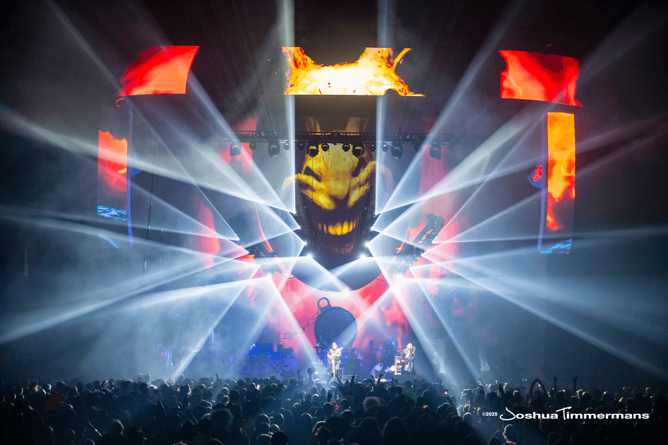 Concert stage production with LED screens, scenic elements, and atmospheric lighting